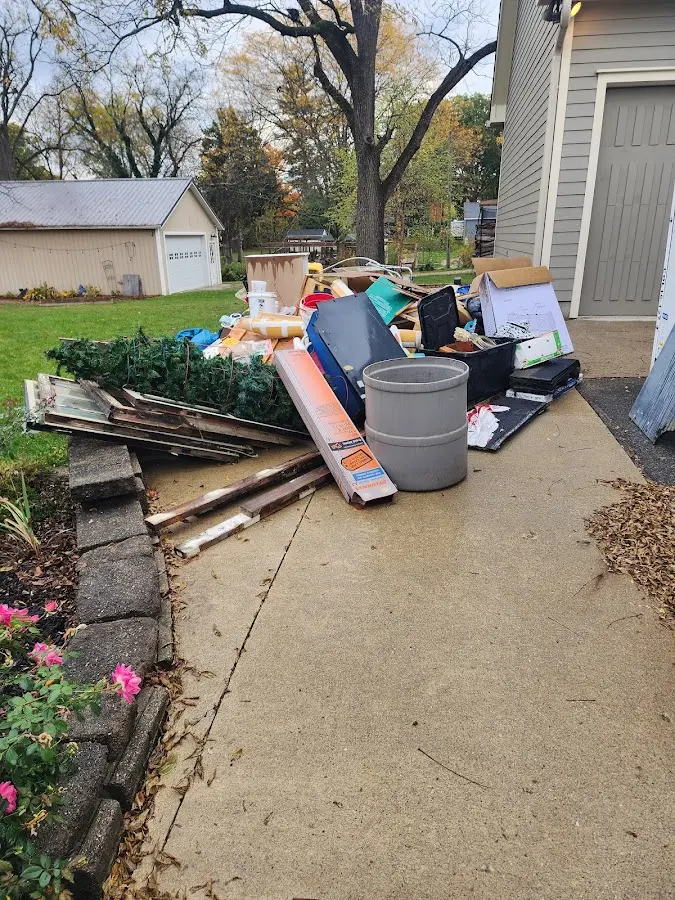 Dumpster being loaded with debris for 12 Yard Dumpster Rental in Hamilton